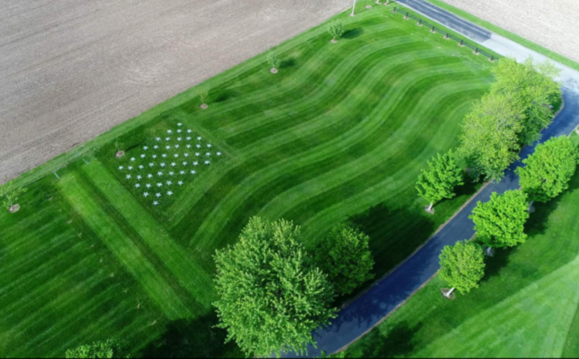 Greenwood man honors local former athlete, fallen soldier by mowing flag in yard